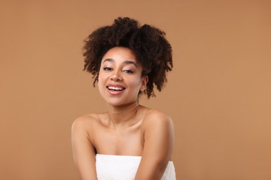 Photo of Portrait of beautiful Brazilian woman after spa treatment on light brown background