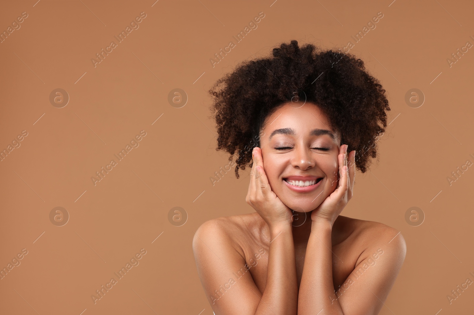 Photo of Portrait of beautiful Brazilian woman after spa treatment on light brown background. Space for text