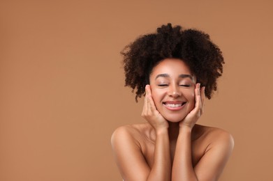 Photo of Portrait of beautiful Brazilian woman after spa treatment on light brown background. Space for text