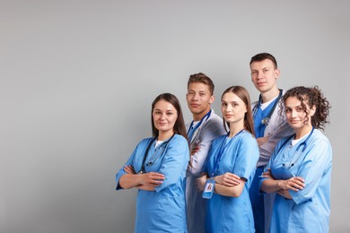 Photo of Group of medical students on light grey background. Space for text
