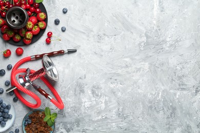 Photo of Hookah and fresh fruits on grey table, flat lay. Space for text