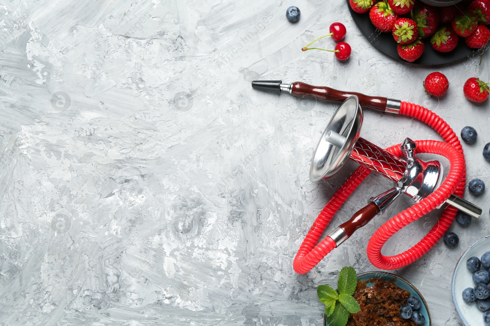 Photo of Hookah and fresh fruits on grey table, flat lay. Space for text