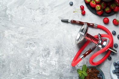 Photo of Hookah and fresh fruits on grey table, flat lay. Space for text