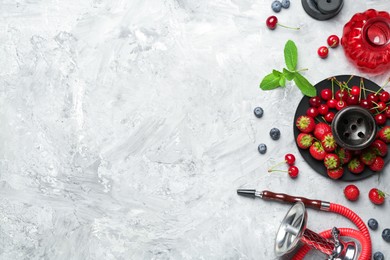 Photo of Hookah and fresh fruits on grey table, flat lay. Space for text