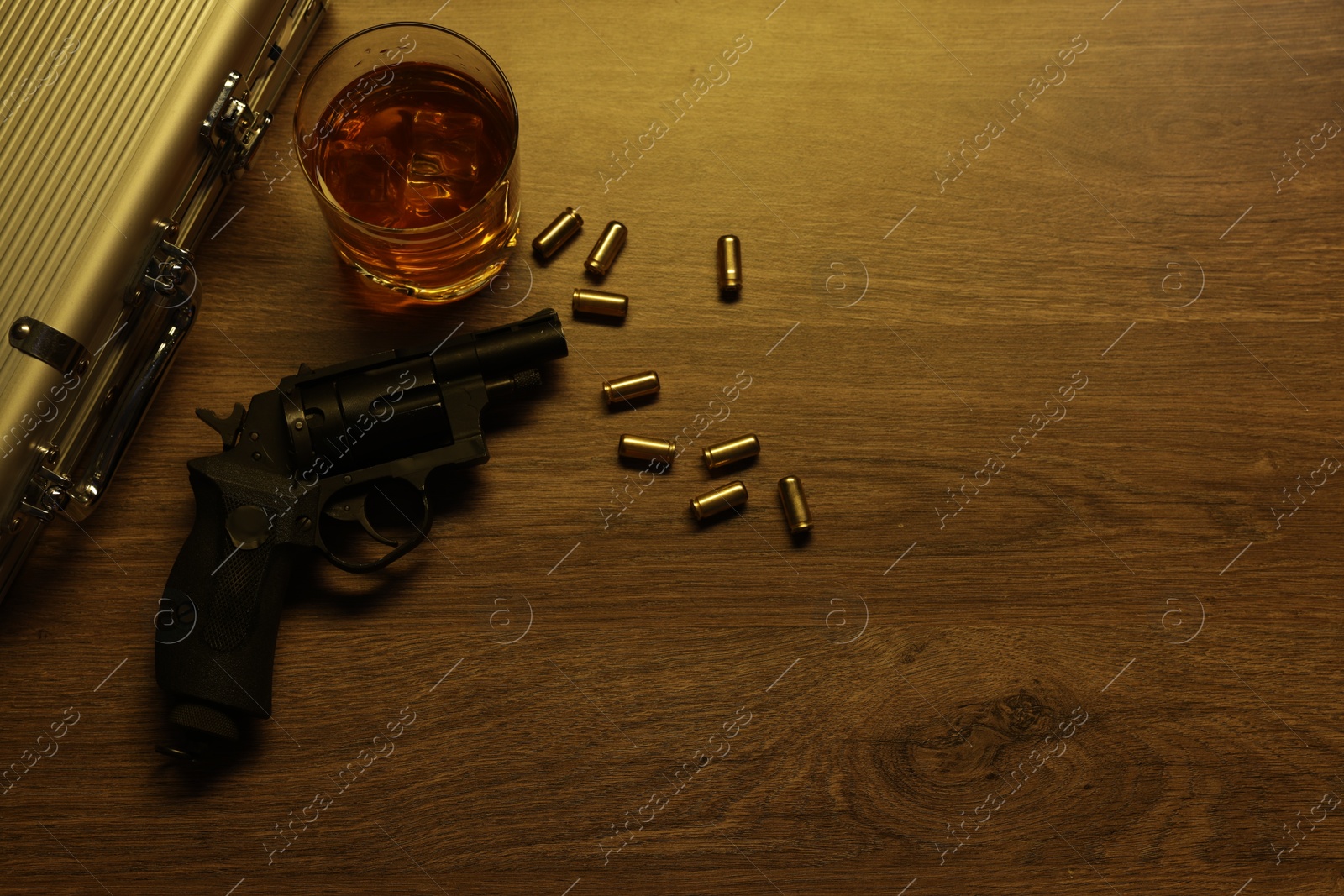 Mafia and criminal world. Gun, bullets, whiskey and briefcase on wooden table, flat lay. Space for text Photo of Mafia and criminal world. Gun, bullets, whiskey and briefcase on wooden table, flat lay. Space for text
