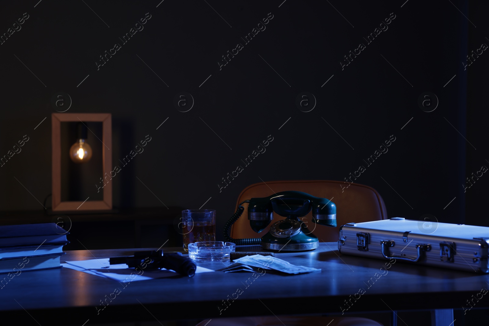 Gun, money, whiskey and other stuff on wooden table in mafia boss office Photo of Gun, money, whiskey and other stuff on wooden table in mafia boss office
