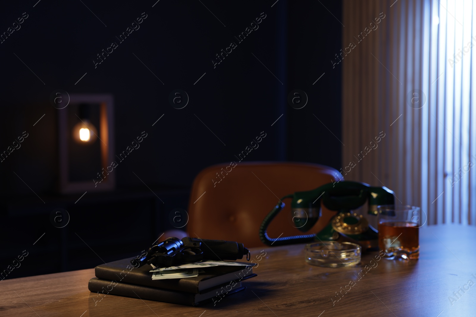 Gun, money, whiskey and other stuff on wooden table in mafia boss office Photo of Gun, money, whiskey and other stuff on wooden table in mafia boss office
