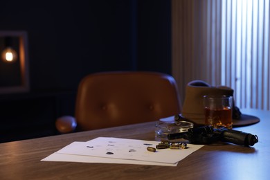 Photo of Gun, fingerprints, whiskey and other stuff on wooden table in mafia boss office