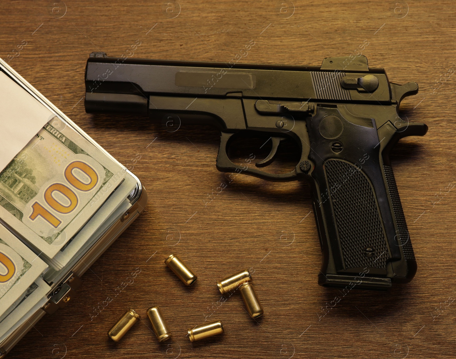 Mafia and criminal world. Gun, bullets and money on wooden table, flat lay Photo of Mafia and criminal world. Gun, bullets and money on wooden table, flat lay