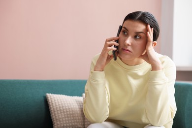 Photo of Young woman complaining to someone via phone at home