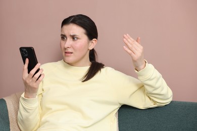 Photo of Young woman complaining to someone via phone at home