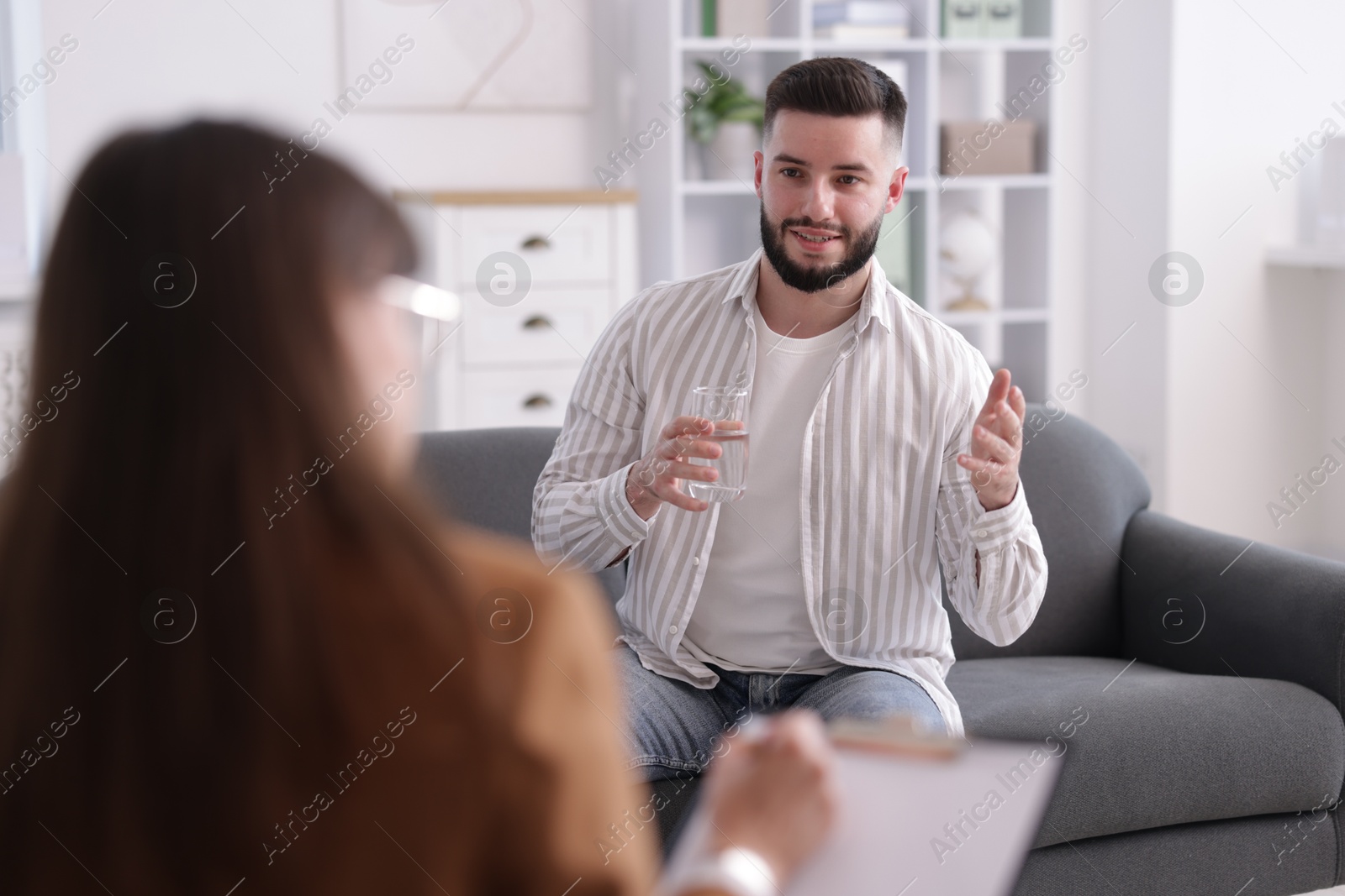 Photo of Professional psychologist working with patient in office, selective focus