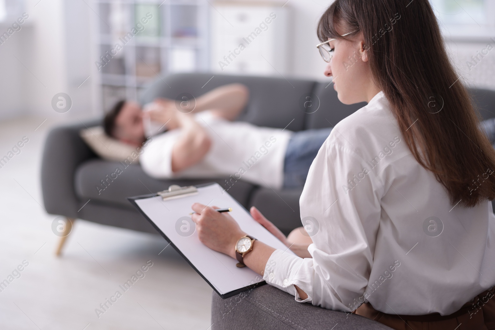 Photo of Professional psychologist working with patient in office, selective focus