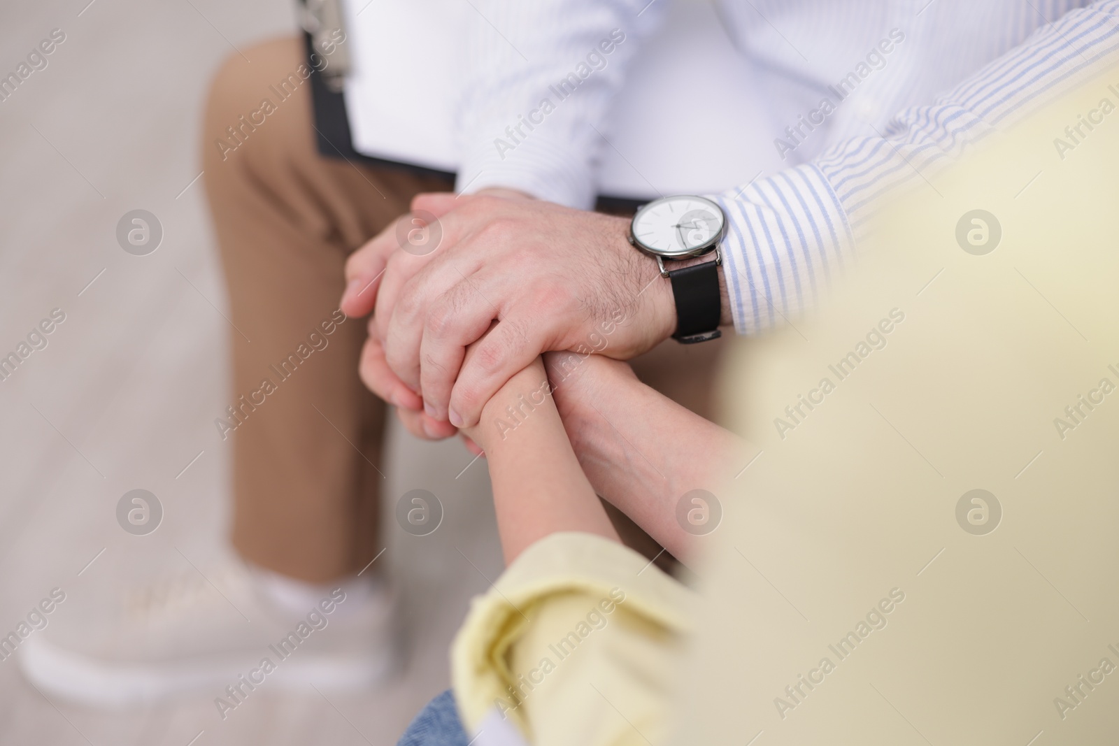 Photo of Psychologist supporting patient during therapy session in office, closeup