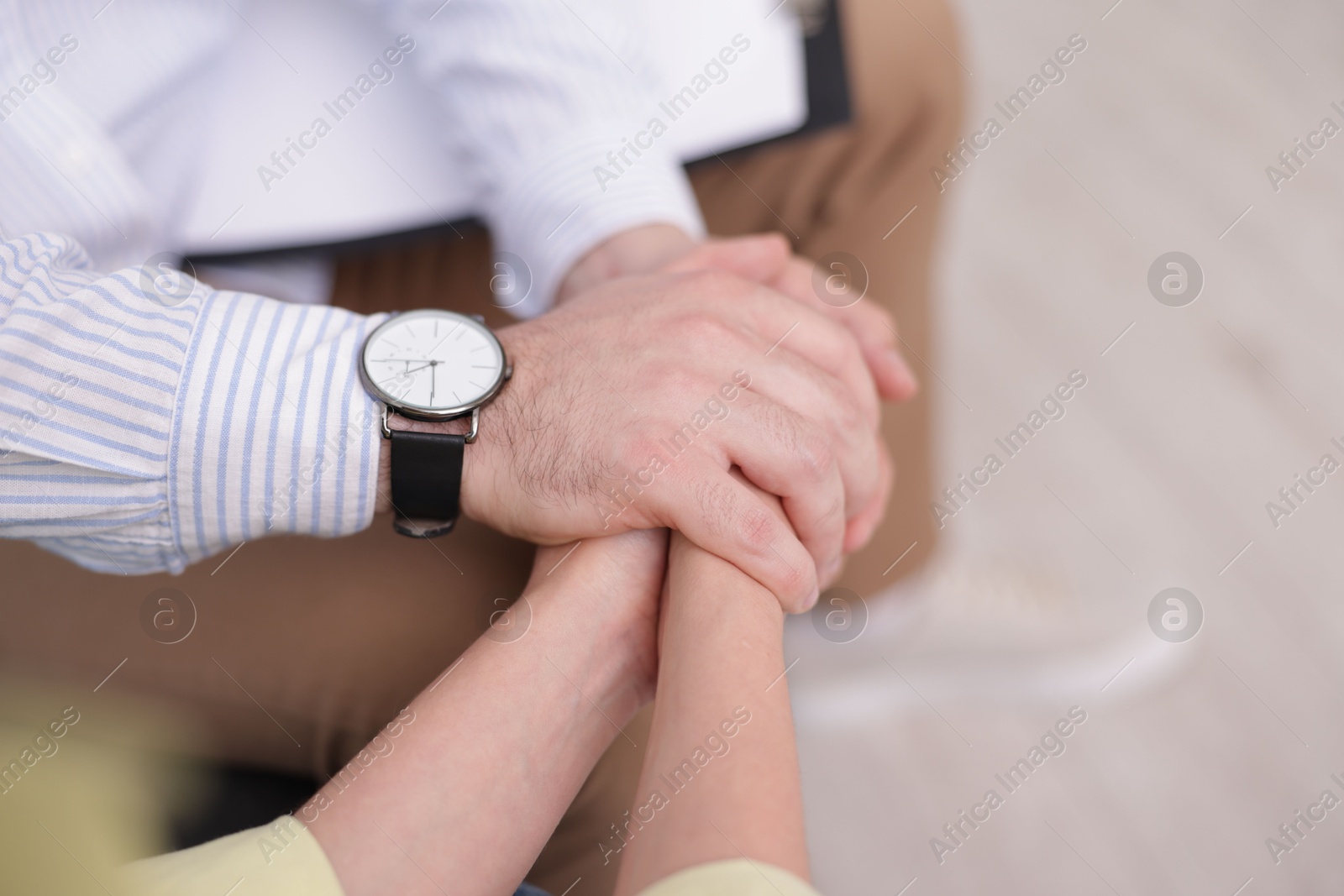 Photo of Psychologist supporting patient during therapy session in office, closeup
