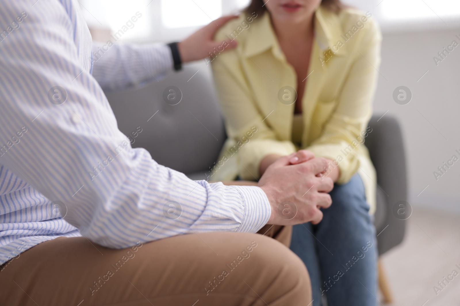 Photo of Psychologist supporting patient during therapy session in office, closeup