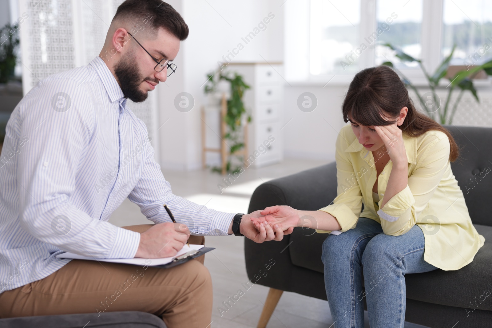 Photo of Psychologist supporting patient during therapy session in office