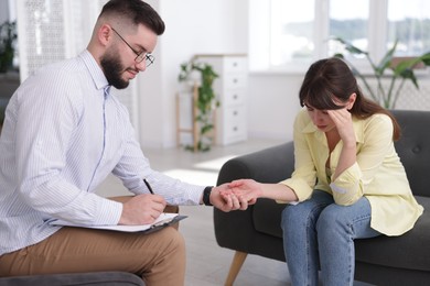 Photo of Psychologist supporting patient during therapy session in office
