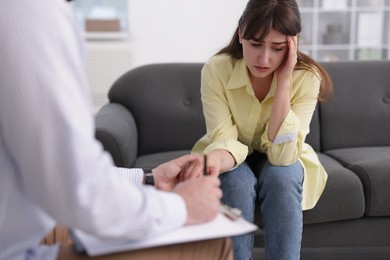 Photo of Psychologist supporting patient during therapy session in office, closeup