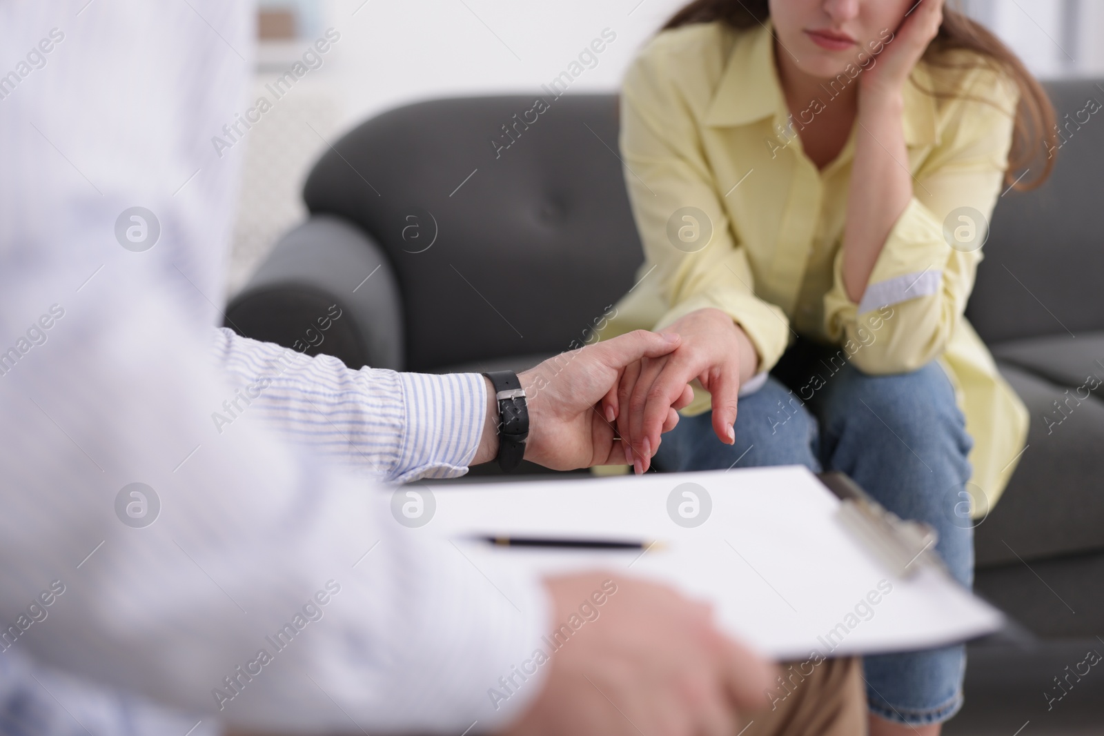 Photo of Psychologist supporting patient during therapy session in office, closeup