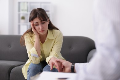 Photo of Psychologist supporting patient during therapy session in office, closeup