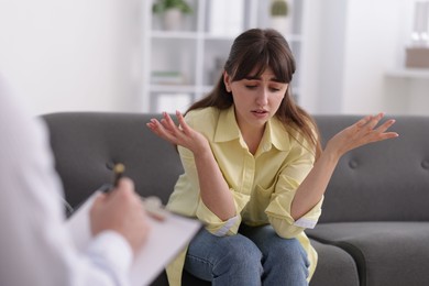 Photo of Professional psychologist working with patient in office, selective focus