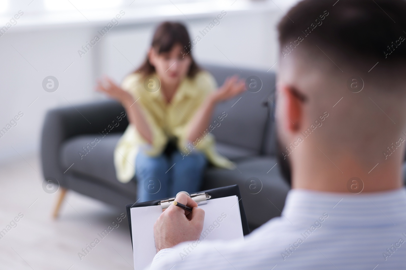 Photo of Professional psychologist working with patient in office, selective focus