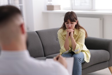 Photo of Professional psychologist working with patient in office, selective focus