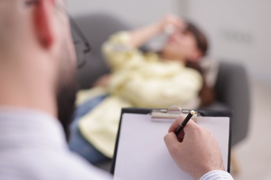 Photo of Professional psychologist working with patient in office, selective focus