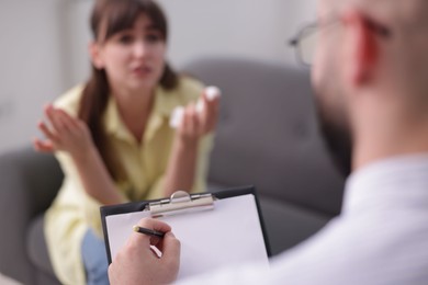 Photo of Professional psychologist working with patient in office, selective focus