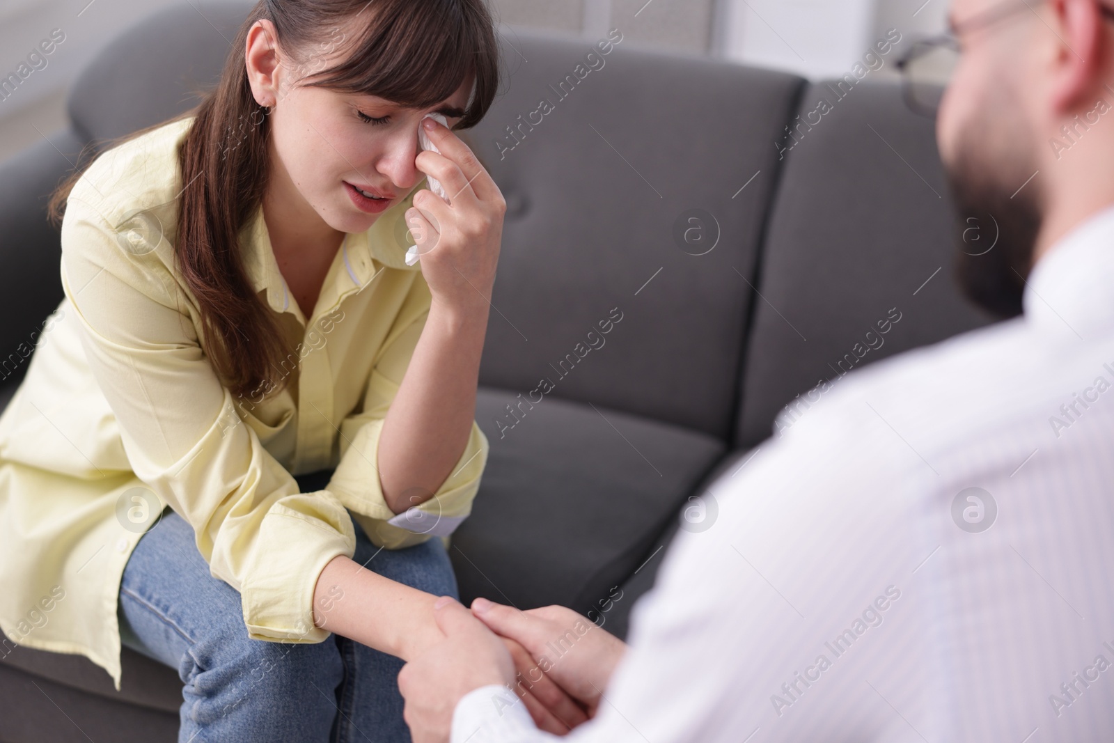 Photo of Psychologist supporting patient during therapy session in office, closeup