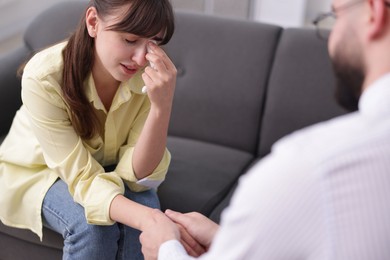 Photo of Psychologist supporting patient during therapy session in office, closeup