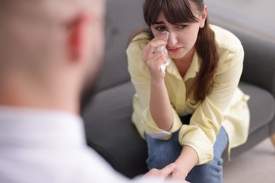 Photo of Psychologist supporting patient during therapy session in office, closeup