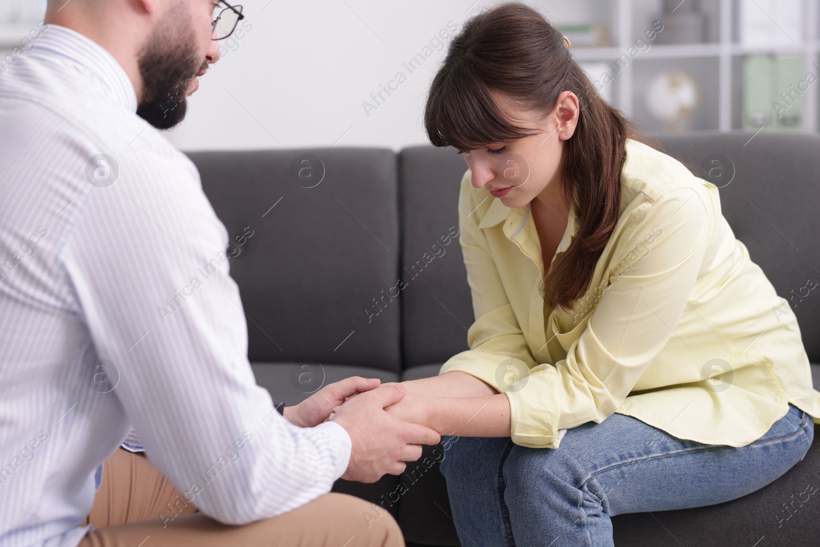 Photo of Psychologist supporting patient during therapy session in office, closeup