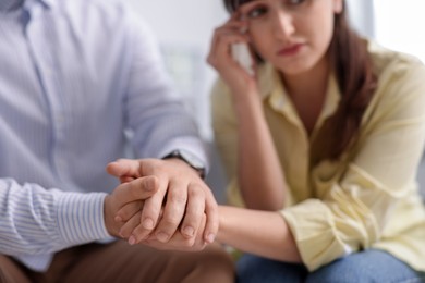 Photo of Psychologist supporting patient during therapy session in office, selective focus