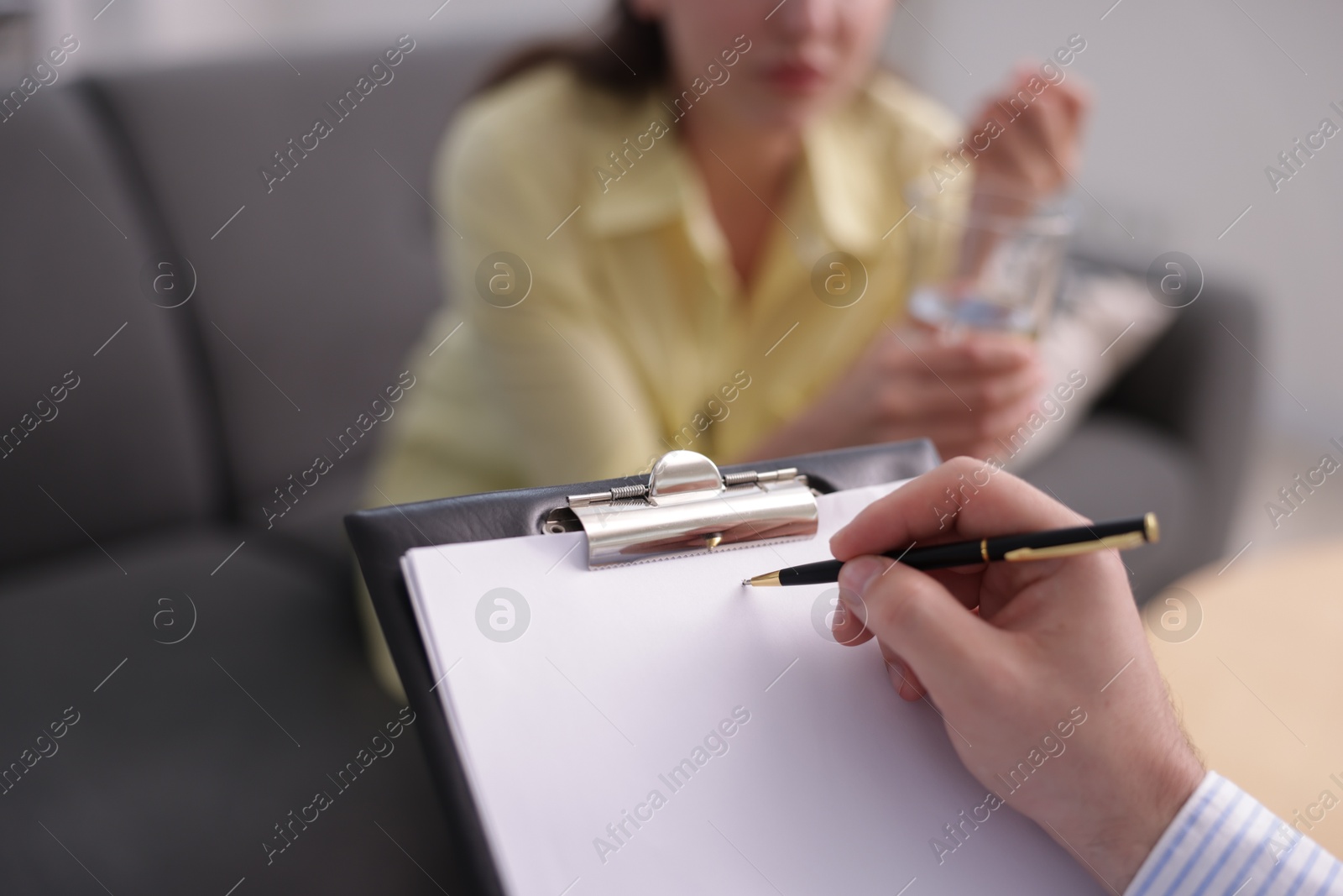 Photo of Professional psychologist working with patient in office, selective focus