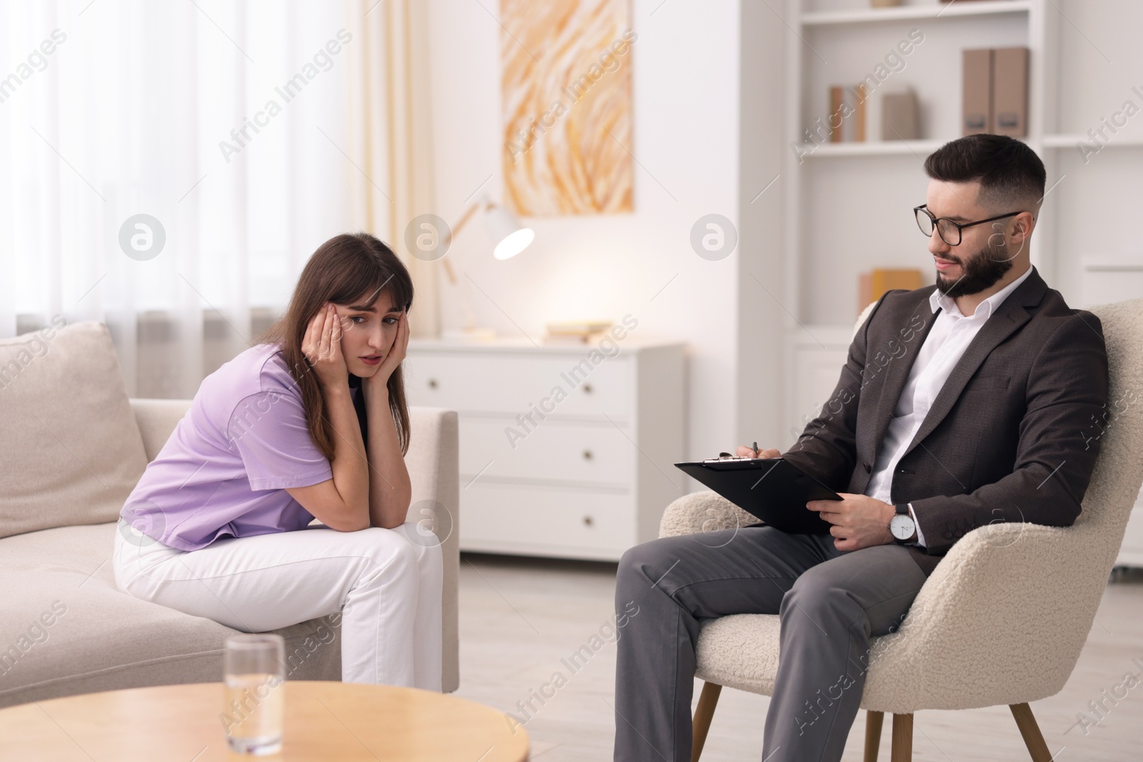 Photo of Professional psychologist working with patient in office