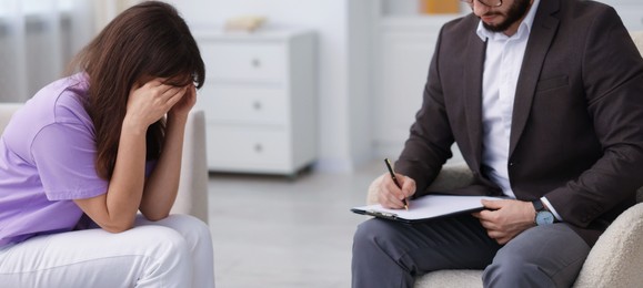 Photo of Professional psychologist working with patient in office, closeup