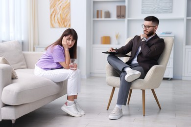 Photo of Professional psychologist working with patient in office