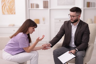 Photo of Professional psychologist working with patient in office
