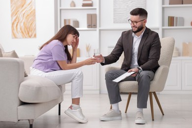 Photo of Professional psychologist working with patient in office
