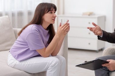 Photo of Professional psychologist working with patient in office, closeup