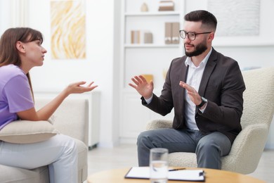 Photo of Professional psychologist working with patient in office