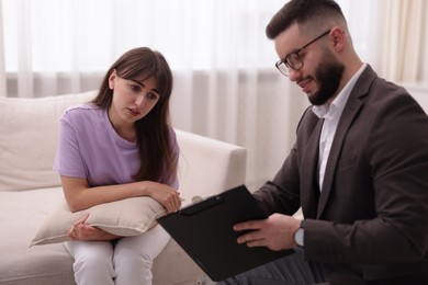 Photo of Professional psychologist working with patient in office