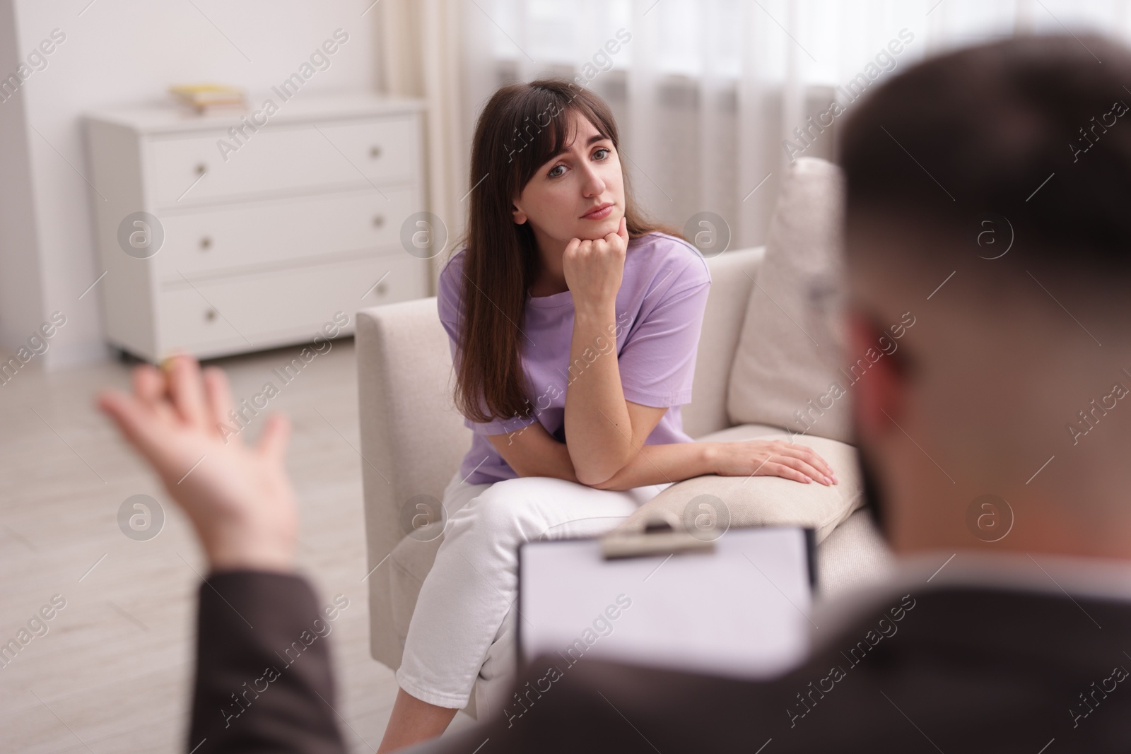Photo of Professional psychologist working with patient in office, selective focus