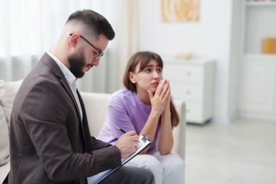 Photo of Professional psychologist working with patient in office, space for text
