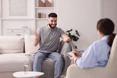 Photo of Professional psychologist working with patient in office, selective focus