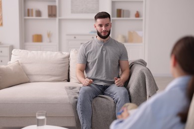Photo of Professional psychologist working with patient in office, selective focus