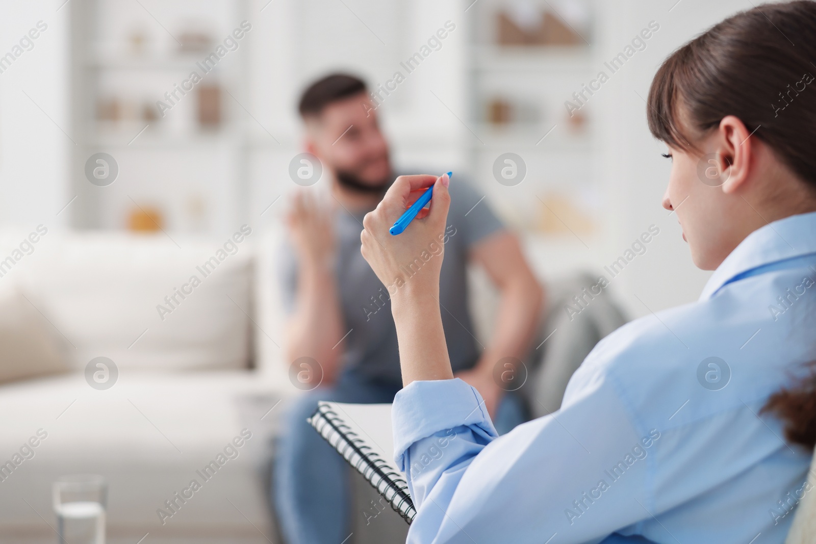 Photo of Professional psychologist working with patient in office, selective focus
