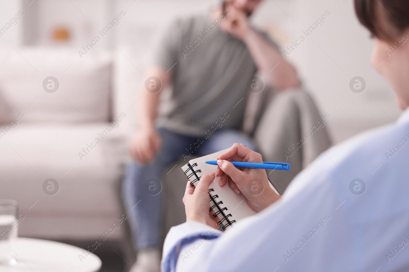 Photo of Professional psychologist working with patient in office, selective focus